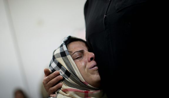 A Palestinian relative cries during the funeral of Mohammed al-Koumi in Gaza City, Wednesday, Nov. 21, 2012. Israeli airstrikes killed three Palestinian journalists in their cars on Tuesday, a Gaza health official and the head of the Hamas-run Al Aqsa TV said. Israel acknowledged targeting the men, claiming they had ties to militants. (AP Photo/Bernat Armangue)