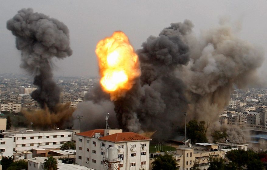 Smoke and a ball of fire are seen after an Israeli air strike in Gaza City, Wednesday, Nov. 21, 2012. Israeli aircraft pounded Gaza with at least 30 strikes overnight, hitting government ministries, smuggling tunnels, a banker's empty villa and a Hamas-linked media office. (AP Photo/Hatem Moussa)