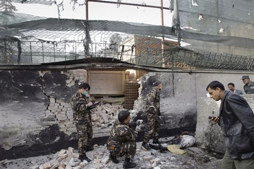 Afghan security men inspect the scene of a suicide attack in Kabul, Afghanistan, Wednesday, Nov. 21, 2012. A man wearing a suicide vest blew himself up near a U.S. base in the Afghan capital early Wednesday, killing at least one person in what looked like a thwarted attempt to attack the American base, police said. (AP Photo/Musadeq Sadeq)