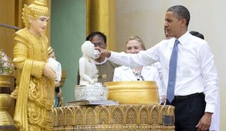 ** FILE ** In this Nov. 19, 2012, photo, President Barack Obama &quot;douses 11 flames&quot; as he tours the Shwedagon Pagoda with Secretary of State Hillary Rodham Clinton in Yangon, Myanmar. Little noticed during Obama&#39;s landmark visit to Myanmar was a significant concession that could shed light on whether that nation&#39;s powerful military pursued a clandestine nuclear weapons program, possibly with North Korea&#39;s help. (AP Photo/Carolyn Kaster)