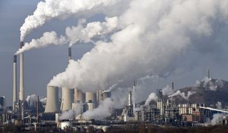 **FILE** Steam and smoke rise from a coal burning power plant in Gelsenkirchen, Germany, on Dec. 16, 2009. (Associated Press)