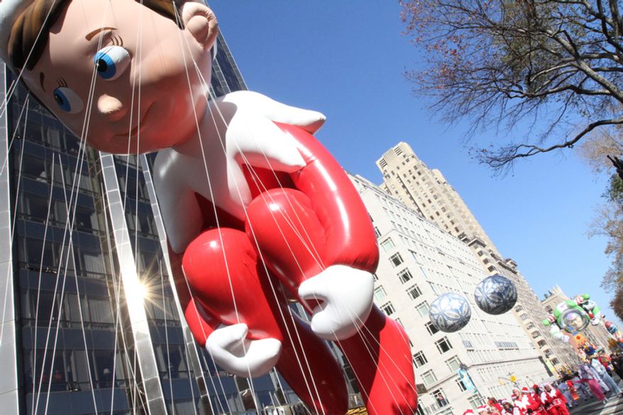 The Elf on the Shelf balloon makes it's way through New York's Columbus Circle during the 86th Annual Macy's Thanksgiving Day Parade Thursday Nov. 22, 2012, in New York. The annual Macy's Thanksgiving Day Parade put a festive mood in the air in a city still coping with the aftermath of Superstorm Sandy. (AP Photo/Tina Fineberg)