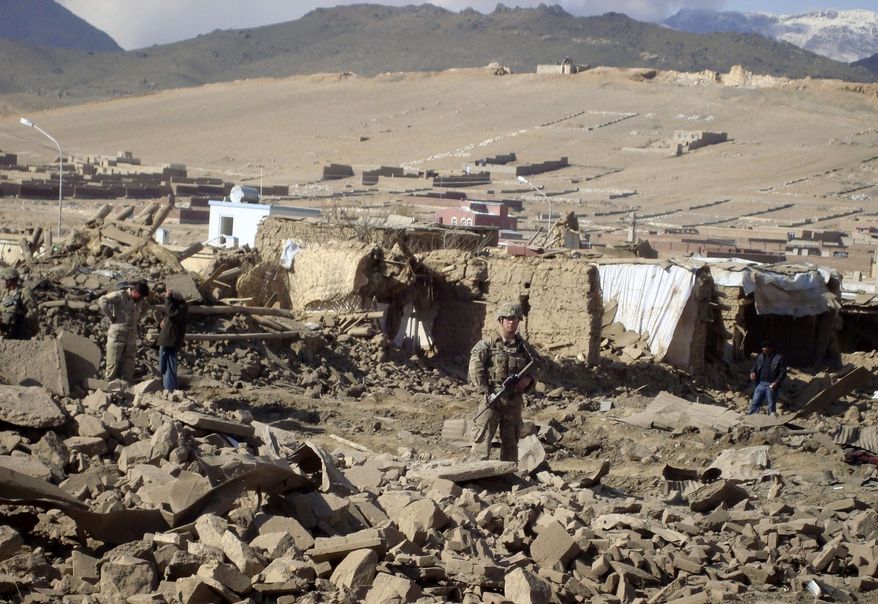 A U.S. soldier stands guard at the site of suicide attack in the Wardak province of Kabul, Afghanistan, on Nov. 23, 2012. A car laden with explosives detonated, killing several civilians and wounding dozens of others, officials said. Taliban spokesman Zabiullah Mujahid claimed responsibility for the bombing. (Associated Press)