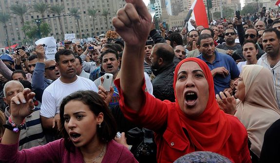 Egyptian protesters opposed to president Mohammed Morsi chant slogans in Tahrir Square in Cairo, Egypt, Friday, Nov. 23, 2012. Opponents and supporters of Mohammed Morsi clashed across Egypt on Friday, the day after the president granted himself sweeping new powers that critics fear can allow him to be a virtual dictator.(AP Photo/Mohammed Asad)