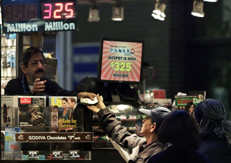 A vendor (left) receives money for a lottery purchase on Nov. 23, 2012, in New York. The jackpot for Powerball's weekend drawing has climbed to $325 million, the fourth-largest in the game's history. (Associated Press)