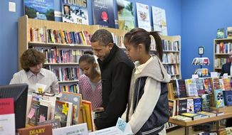 President Barack Obama, with daughters Sasha, left, and Malia, right, goes shopping at a small bookstore, One More Page, in Arlington, Va., Saturday, Nov. 24, 2012. (AP Photo/J. Scott Applewhite)