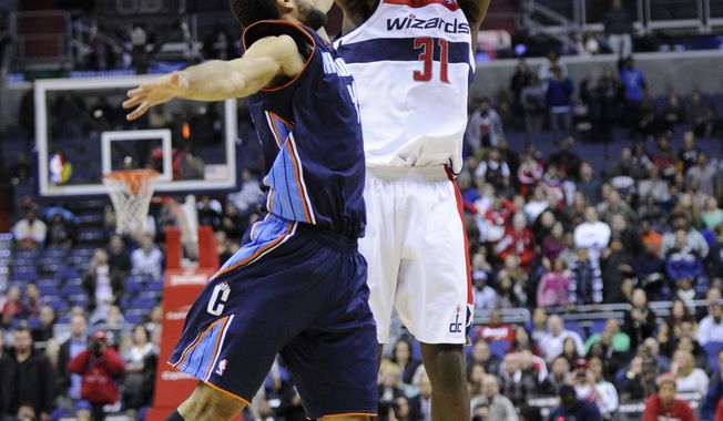 Washington Wizards forward Chris Singleton (31) shoots against Charlotte Bobcats forward Jeffery Taylor, left, during the first overtime period of an NBA basketball game on Saturday, Nov. 24, 2012, in Washington. Charlotte won 108-106. (AP Photo/Nick Wass)