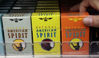 FILE - In this Tuesday, Feb. 1, 2011 file photo, Reynolds American cigarette brand American Spirit are on display at a liquor store in Palo Alto, Calif. (AP Photo/Paul Sakuma, File)