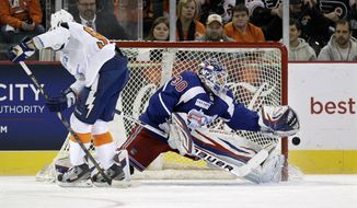 New York Team goalie Henrik Lundqvist, of Sweden makes a save on a penalty shot by New Jersey Team&#39;s Steve Stamkos (91) during the first period of a charity hockey game in Atlantic City, N.J., Saturday, Nov. 24, 2012.  (AP Photo/Mel Evans)