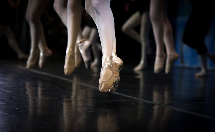 Dancers jump and dance for practice prior to their performance of The Nutcracker at W.T. Woodson High School in Fairfax, Va. on the final day of the show which is presented by the Fairfax Ballet 2012. (Rod Lamkey Jr./The Washington Times)