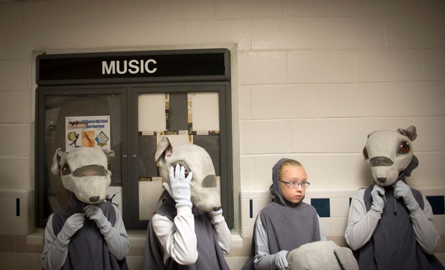 Young dancers playing the part of the mice get ready to take to the stage in the hallway for The Nutcracker at W.T. Woodson High School. (Rod Lamkey Jr./The Washington Times)