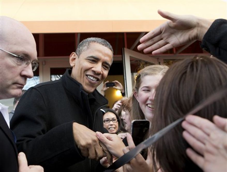 President Obama shakes hands outside a small bookstore in Arlington, Va., Saturday, Nov. 24, 2012, where he went shopping with his daughters. (AP Photo/J. Scott Applewhite)