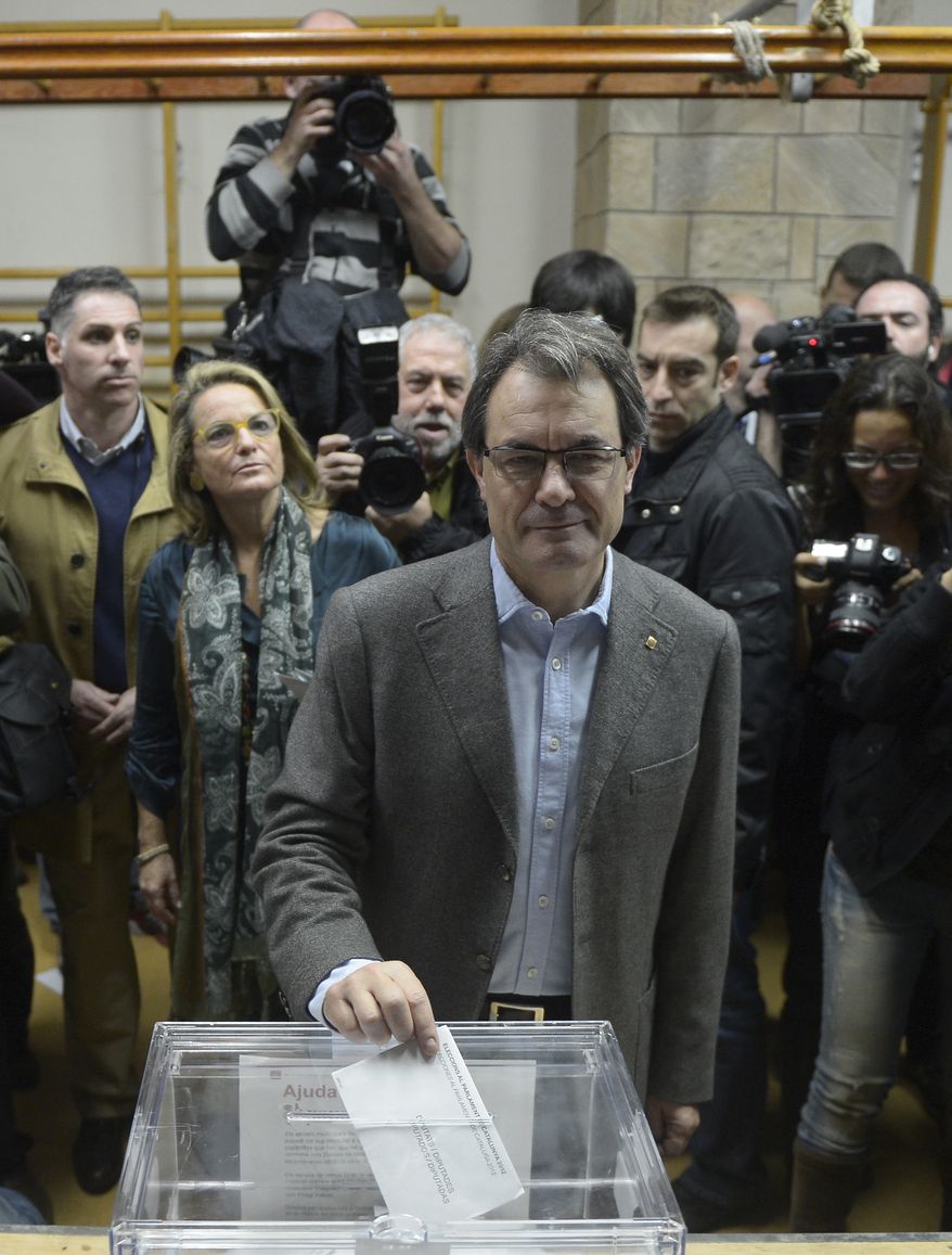 Artur Mas, leader of the center-right Catalan Nationalist Coalition (CiU) party, casts his vote in Barcelona during Catalan regional elections on Sunday, Nov. 25, 2012. (AP Photo/Manu Fernandez)