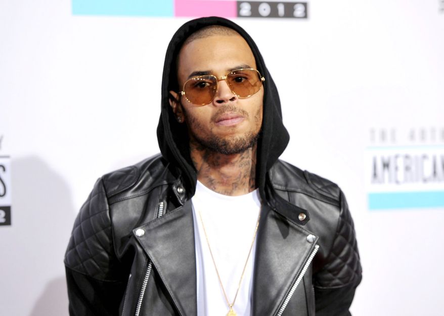 Chris Brown arrives at the 40th Anniversary American Music Awards on Sunday, Nov. 18, 2012, in Los Angeles. (Invision via Associated Press)