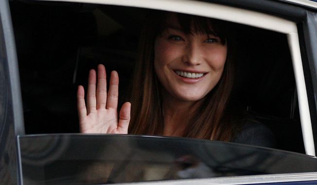 Carla Bruni-Sarkozy, wife of former French President Nicolas Sarkozy, said she and her husband disagree on the issue of gay marriage and adoption. She’s in favor of both. (Associated Press)