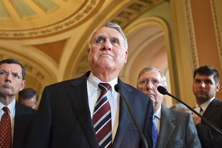 Senate Minority Whip Jon Kyl, R-Ariz., center, takes a question on the controversial Arizona immigration law that will be argued in the Supreme Court tomorrow, at a news conference following a Republican strategy session at the Capitol in Washington, Tuesday, April 24, 2012. Sen. John Barrasso, R-Wyo., Republican Policy Committee chair listens at left, with Senate Minority Leader Mitch McConnell, R-Ky., at right. (AP Photo/J. Scott Applewhite)