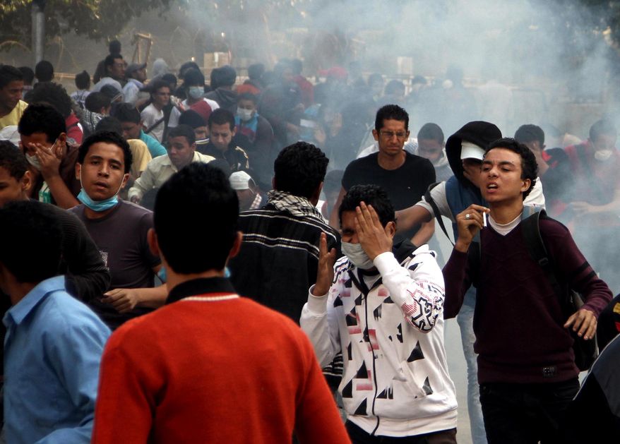 Egyptian protesters clash with security forces (not pictured) near Tahrir Square in Cairo on Sunday, Nov. 25, 2012. (AP Photo/Ahmed Gomaa)