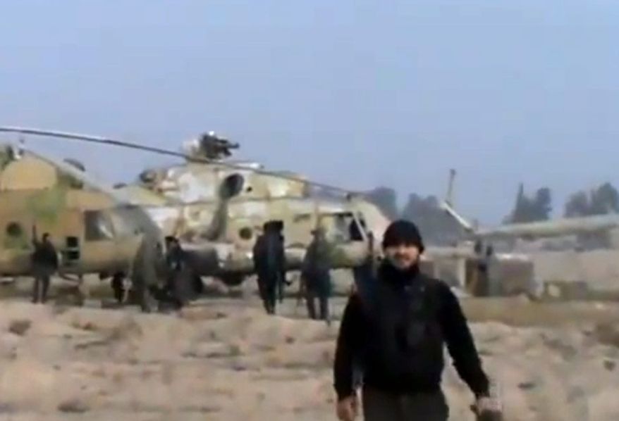 In this image taken from video obtained from the Ugarit News, which has been authenticated based on its contents and other AP reporting, Syrian rebels capture a helicopter air base near the capital, Damascus, after fierce fighting on Sunday, Nov. 25, 2012. The takeover claim showed how rebels are advancing in the area of the capital, though they are badly outgunned by President Bashar Assad's forces, making inroads where Mr. Assad's power was once unchallenged. Rebels have also been able to fire mortar rounds into Damascus recently. (AP Photo/Ugarit News via AP video)