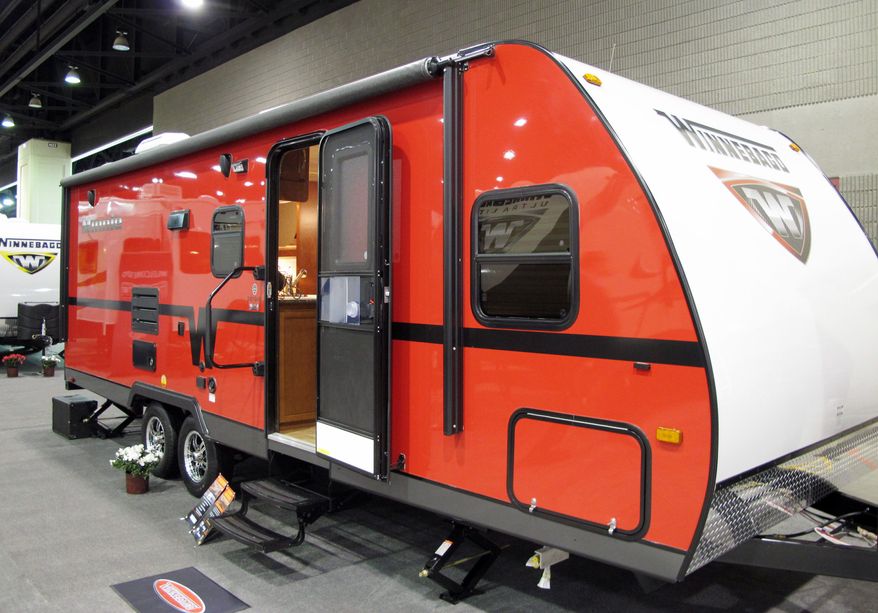 Recreational-vehicle maker Winnebago shows off its Minnie towable RV at a trade show Tuesday in Louisville, Ky. Cash-conscious consumers are choosing less-expensive RVs that are hitched to the backs of other vehicles. (Associated Press)