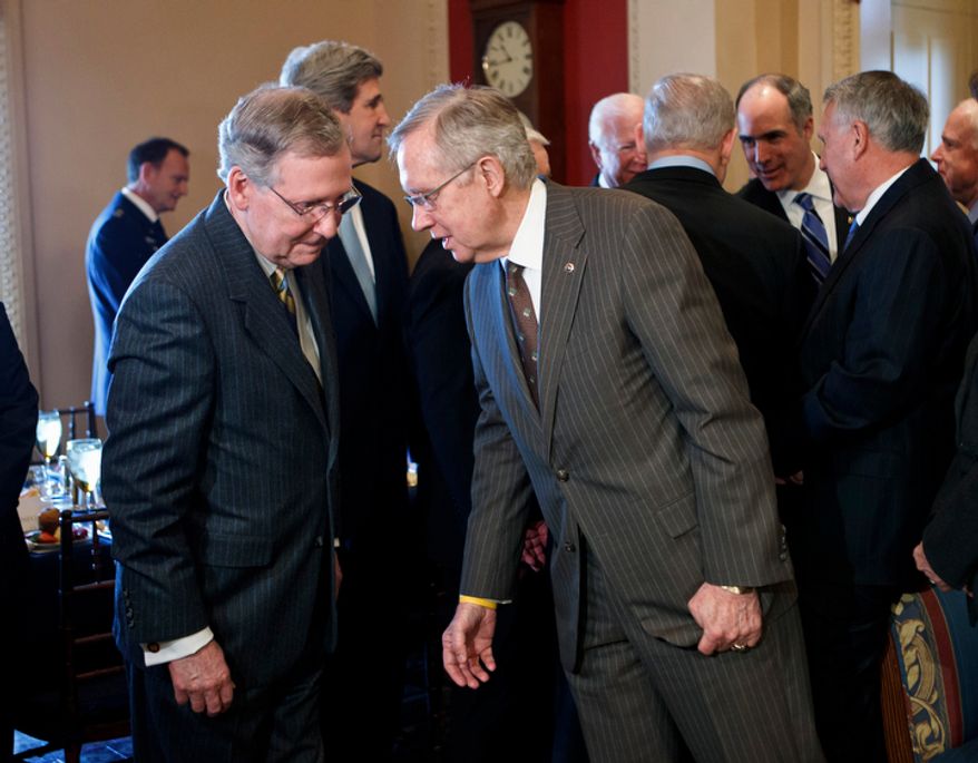 Senate Majority Leader Harry Reid (right), Nevada Democrat, and Minority Leader Mitch McConnell, Kentucky Republican, confer on Capitol Hill in Washington on Tuesday, March 6, 2012, while awaiting the arrival of Israeli Prime Minister Benjamin Netanyahu. Sen. John F. Kerry, Massachusetts Democrat, is at center; Sen. Jon Kyl, Arizona Republican, is at right; Sen. Robert P. Casey Jr., Pennsylvania Democrat, is second from right. (AP Photo/J. Scott Applewhite)