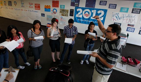 Brian Conklin (far right), a regional campaign director for President Obama, briefs volunteers about registering new voters prior before they canvass a heavily Latino neighborhood on Friday, June 29, 2012, in Phoenix.  Across the country, both political parties have been courting the Latino vote, the nation&#39;s fastest-growing minority group. (AP Photo/Ross D. Franklin)