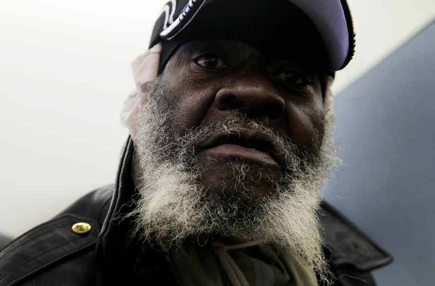 Paul Hunter, whose home was flooded in superstorm Sandy, waits for assistance at an NYC Restore location in the Far Rockaway section of the New York borough of Queens on Tuesday, Nov. 13, 2012. (AP Photo/Mark Lennihan)
