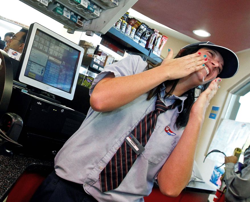 Tanice Stefanich, a cashier at the 4 Sons Food Store in Fountain Hills, Ariz., reacts Thursday to all the attention of shoppers and the media resulting from the sale of one of two winning Powerball lottery tickets there. The lucky ticket purchaser, yet to come forward, will split a $588 million jackpot. (Associated Press)