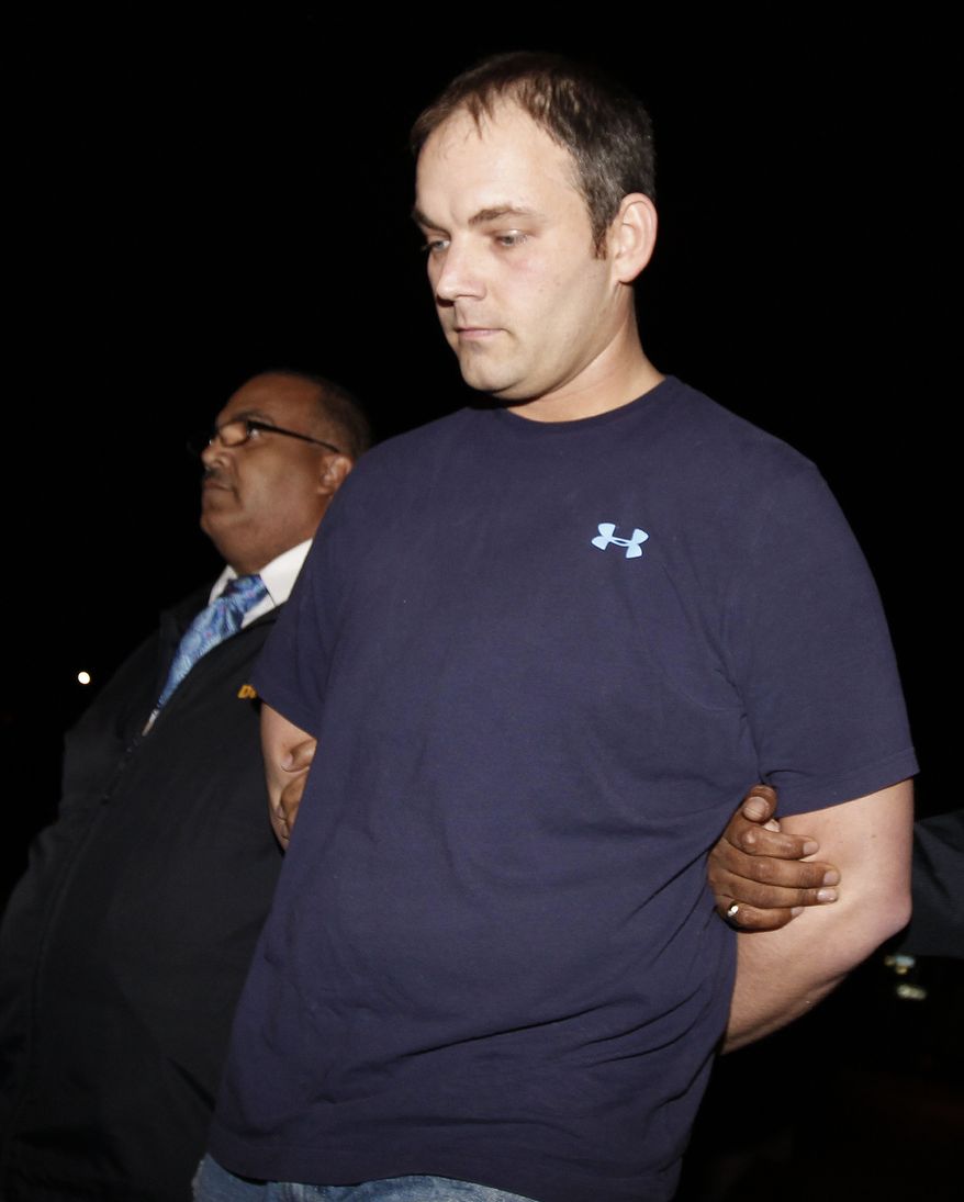 FILE - - In this Thursday, Jan. 19, 2012 file photo, Brian Downing, who allegedly sexually assaulted a passed out LSU football fan, is escorted by detectives for booking at the New Orleans Police Department headquarters in New Orleans. Downing got a dressing-down and two years in prison for rubbing his genitals on an unconscious LSU fan in a Bourbon Street burger restaurant after the BCS national title game in January. A video of the incident went viral. On Thursday, Nov. 29, 2012 State District Judge Karen Herman told Downing of Smiths Station, Ala., that he’s a bully who has permanently damaged someone else’s life. Downing declined to say anything before the judge sentenced him as part of a plea deal. He pleaded guilty in October to two counts of obscenity. (AP Photo/Gerald Herbert, File)