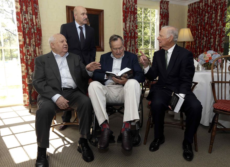 Former President of the Soviet Union Mikhail Gorbachev, left, visits with former President George H.W. Bush, center, and former Secretary of State James Baker, right, before having lunch Thursday, Nov. 1, 2012, in Houston. Gorbachev is in Houston to speak at the Brilliant Lecture Series. Standing behind is Gorbachev's adviser Paval Palazhchenko. (AP Photo/David J. Phillip)