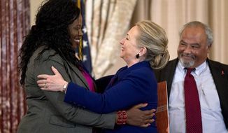 Secretary of State Hillary Rodham Clinton greets Florence Ngobeni-Allen, ambassador for the Elizabeth Glaser Pediatric AIDS Foundation, Thursday, Nov. 29, 2012, during a ceremony in recognition of World AIDS Day, where she released The U.S. President&#39;s Emergency Plan for AIDS Relief (PEPFAR) Blueprint for Creating an AIDS- Free Generation. At right US Global AIDS Coordinator Eric P. Goosby. (AP Photo/Jose Luis Magana)