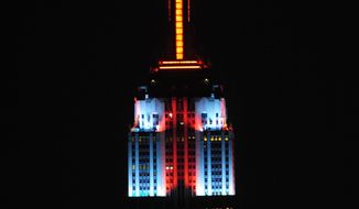 The top floors of New York&#39;s Empire State Building are lit in gold, red, blue and white light on Monday, Nov. 26, 2012, after a new LED illumination system was switched on by R&amp;B star Alicia Keys. (AP Photo/Empire State Building, Bryan Smith)
