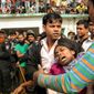 ** FILE ** People console a woman whose relative was killed in a fire at a garment factory outside Dhaka, Bangladesh, Sunday, Nov. 25, 2012. At least 112 people were killed late Saturday night in a fire that raced through the multi-story garment factory just outside of Bangladesh&#39;s capital, an official said Sunday. (AP Photo/Hasan Raza)