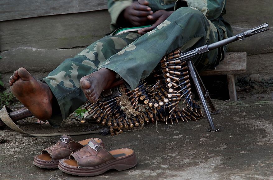 A soldier of the Mai Mai militia rests in Kirotshe, some 30 kms south-west of Goma, Thursday Nov. 29, 2012. M23 Rebels, who last week seized one of the most important cities in eastern Congo and advanced beyond, said Thursday that they had pulled back several miles (kilometers ) to the town of Sake and were on track to leave the key city of Goma by Friday, in accordance with a deadline imposed by the international community. Government troops were massing in Minova.(AP Photo/Jerome Delay)