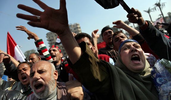 Egyptian protesters chant anti-Muslim Brotherhood slogans as they attend a rally in Tahrir Square, in Cairo, Egypt, Friday, Nov. 30, 2012. Egypt&#39;s opposition has called for a major rally Friday in Cairo&#39;s Tahrir Square, where some demonstrators have camped out in tents since last week to protest decrees that President Mohammed Morsi issued to grant himself sweeping powers. Hundreds gathered in the plaza for traditional Friday prayers, then broke into chants of &quot;The people want to bring down the regime!&quot; &amp;#195;&amp;#179; echoing the refrain of the Arab Spring revolts, but this time against a democratically elected leader. Other cities around Egypt braced for similar protests.(AP Photo/Khalil Hamra)