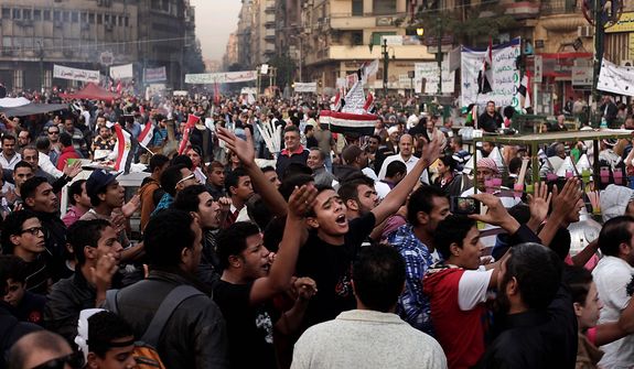 Egyptians chant slogans during a demonstration in Tahrir Square, Cairo, Egypt, Friday, Nov. 30, 2012. Liberal and secular parties held major protests against Egyptian President Mohammed Morsi&#39;s latest decrees granting himself almost complete powers. (AP Photo/Nariman El-Mofty)