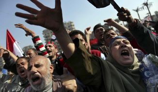 Egyptian protesters chant anti-Muslim Brotherhood slogans as they attend a rally in Tahrir Square, in Cairo, Egypt, Friday, Nov. 30, 2012. (AP Photo/Khalil Hamra)

