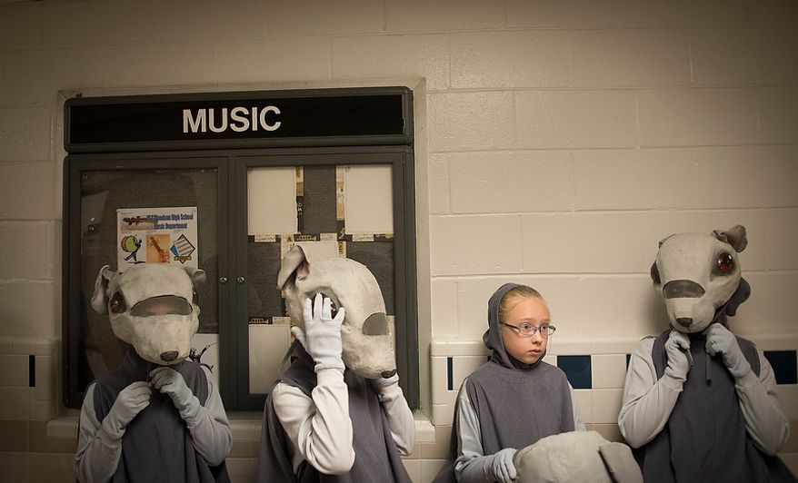 Young dancers playing the part of the mice get ready to take to the stage in the hallway for The Nutcracker at W.T. Woodson High School in Fairfax, Va., Sunday, Nov. 25, 2012. This is the final day of the show which is presented by the Fairfax Ballet 2012. (Rod Lamkey Jr./The Washington Times)