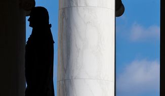 A man admires the 19-foot-tall, 10,000-pound bronze statue of our third President of the United States, Thomas Jefferson, inside the Jefferson Memorial in Washington, D.C., on Wednesday, November 28, 2012. (Craig Bisacre/The Washington Times) 