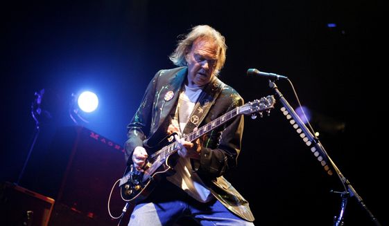 Neil Young performs at Madison Square Garden in New York on Monday, Dec. 15, 2008. (AP Photo/Jason DeCrow)
