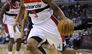 Washington Wizards shooting guard Bradley Beal (3) dribbles against the Charlotte Bobcats during the second half of an NBA basketball game, Saturday, Nov. 24, 2012, in Washington. Charlotte won 108-106 in double overtime. (AP Photo/Nick Wass)
