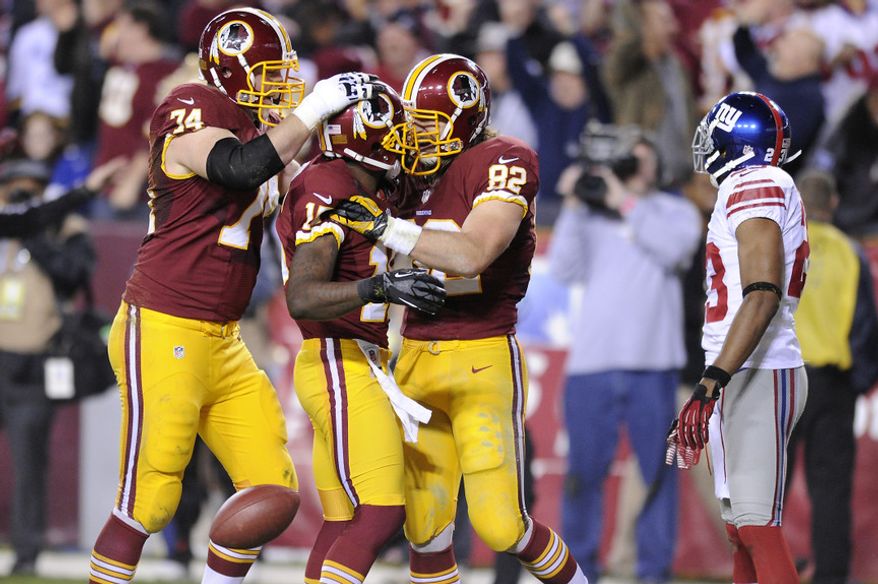 Washington Redskins wide receiver Josh Morgan celebrates his first quarter touchdown with tackle Tyler Polumbus (74) and tight end Logan Paulsen (82) at FedEx Field, Landover, Md., Dec. 3, 2012. (Preston Keres/Special to The Washington Times)