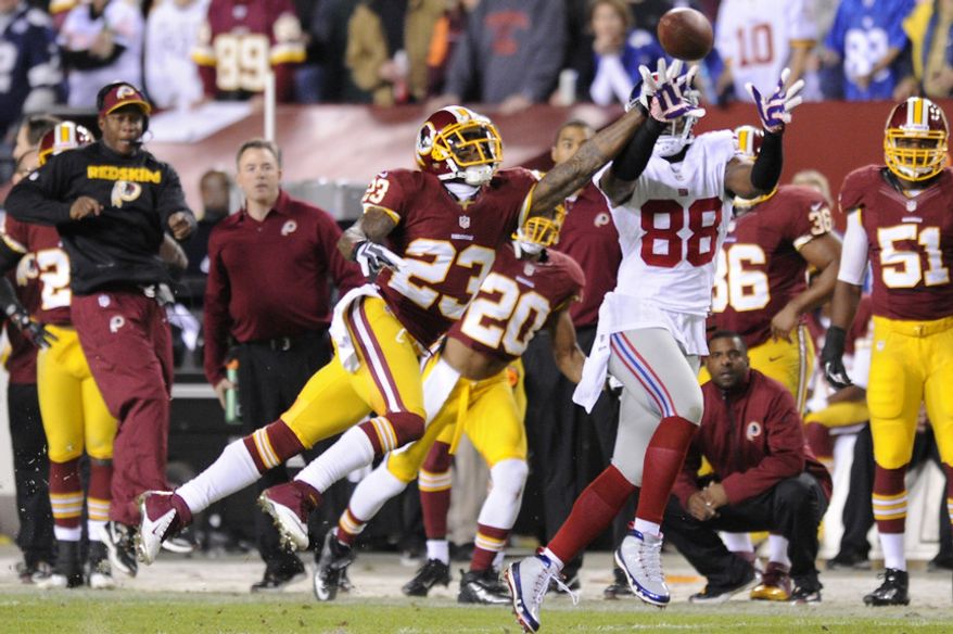 New York Giants wide receiver Hakeem Nicks (88) hauls in a first quarter pass in front of Washington Redskins cornerback DeAngelo Hall (23) at FedEx Field, Landover, Md., Dec. 3, 2012. (Preston Keres/Special to The Washington Times)