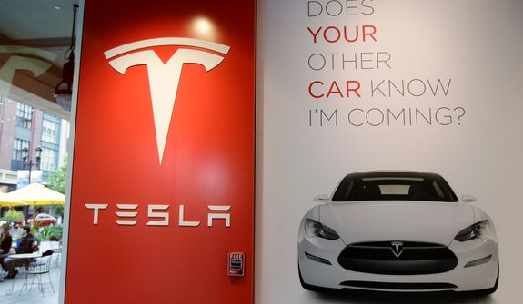**FILE** A sign is shown inside of electric car maker Tesla Motors showroom in San Jose, Calif., on May 25, 2011. (Associated Press)