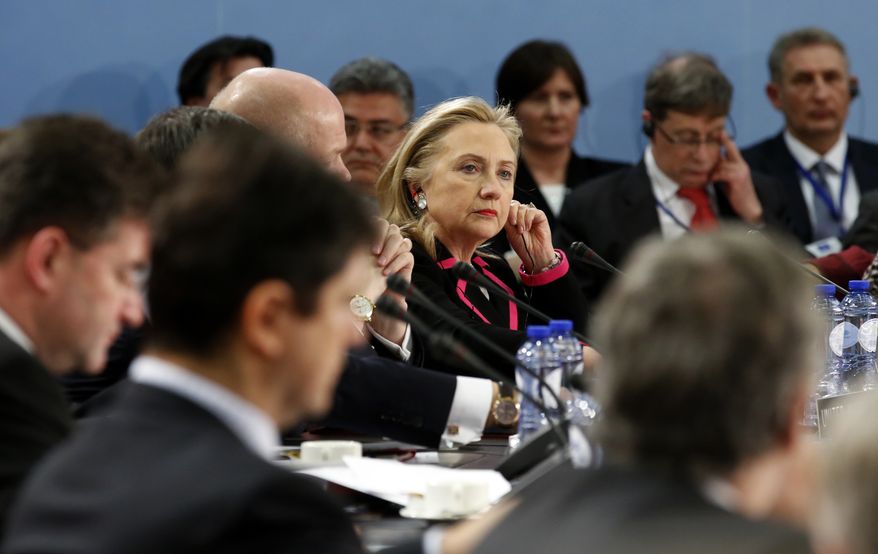 Secretary of State Hillary Rodham Clinton listens during a meeting of NATO foreign ministers at the alliance's headquarters in Brussels on Tuesday, Dec. 4, 2012. (AP Photo/Kevin Lamarque, Pool)