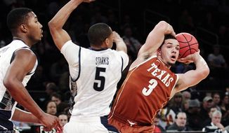 Texas&#39; Javan Felix (3) looks to pass away from Georgetown&#39;s Markel Starks (5) during the second half of their NCAA college basketball game in the Jimmy V Classic at Madison Square Garden, Tuesday, Dec. 4, 2012, in New York. Georgetown won 64-41. (AP Photo/Frank Franklin II)