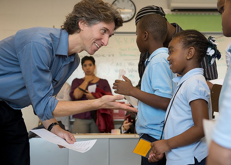 Damian Woetzel, left, a former principal dancer with the New York City Ballet, tries to get Jionni Anderson, a from Savoy Elementary School in Southeast Washington, D.C., to emote during a rehearsal of a poem/performance piece that he and cellist Yo Yo Ma created during a special workshop on Tuesday, Dec. 4, 2012. Following a private rehearsal the students and the artists performed for the entire school. (Barbara L. Salisbury/The Washington Times)