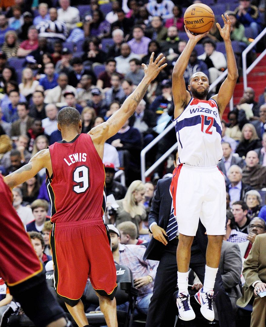 Wizards guard A.J. Price prepares to release a shot against Heat forward Rashard Lewis during Washington's 105-101 win Tuesday night at Verizon Center. (Associated Press)