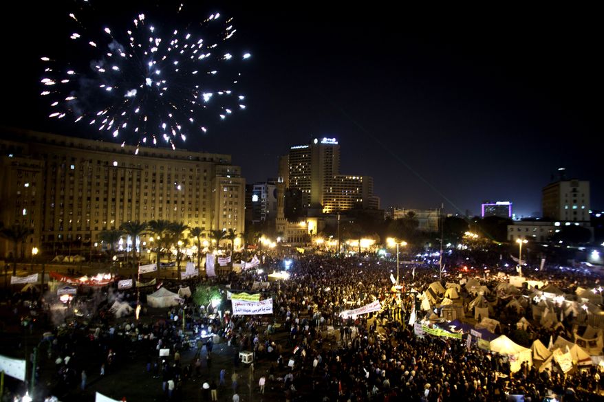Fireworks burst over Tahrir Square as demonstrators gather in Cairo on Tuesday, Dec. 4, 2012, to protest Islamist President Mohammed Morsi's seizure of nearly unrestricted powers. (AP Photo/Maya Alleruzzo)