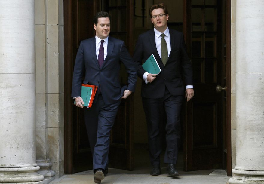 George Osborne (left), Britain's chancellor of the exchequer, walks with Danny Alexander, chief secretary to the treasury, to deliver the half-yearly budget statement to Parliament in London on Dec. 5, 2012. (Associated Press)