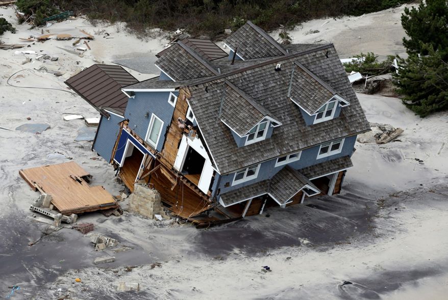 ** FILE ** This Wednesday, Oct. 31, 2012, file aerial photo shows a collapsed house along the central Jersey Shore coast. (AP Photo/Mike Groll, File)
